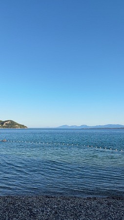 Klidné moře s průzračnou vodou a obzorem pod jasně modrou oblohou