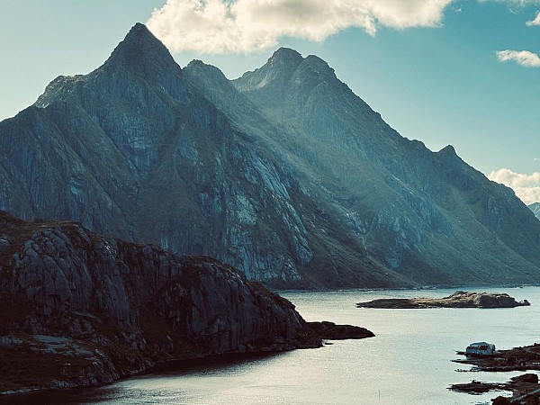 Horské masivy se strmými svahy obklopují úzké vodní údolí